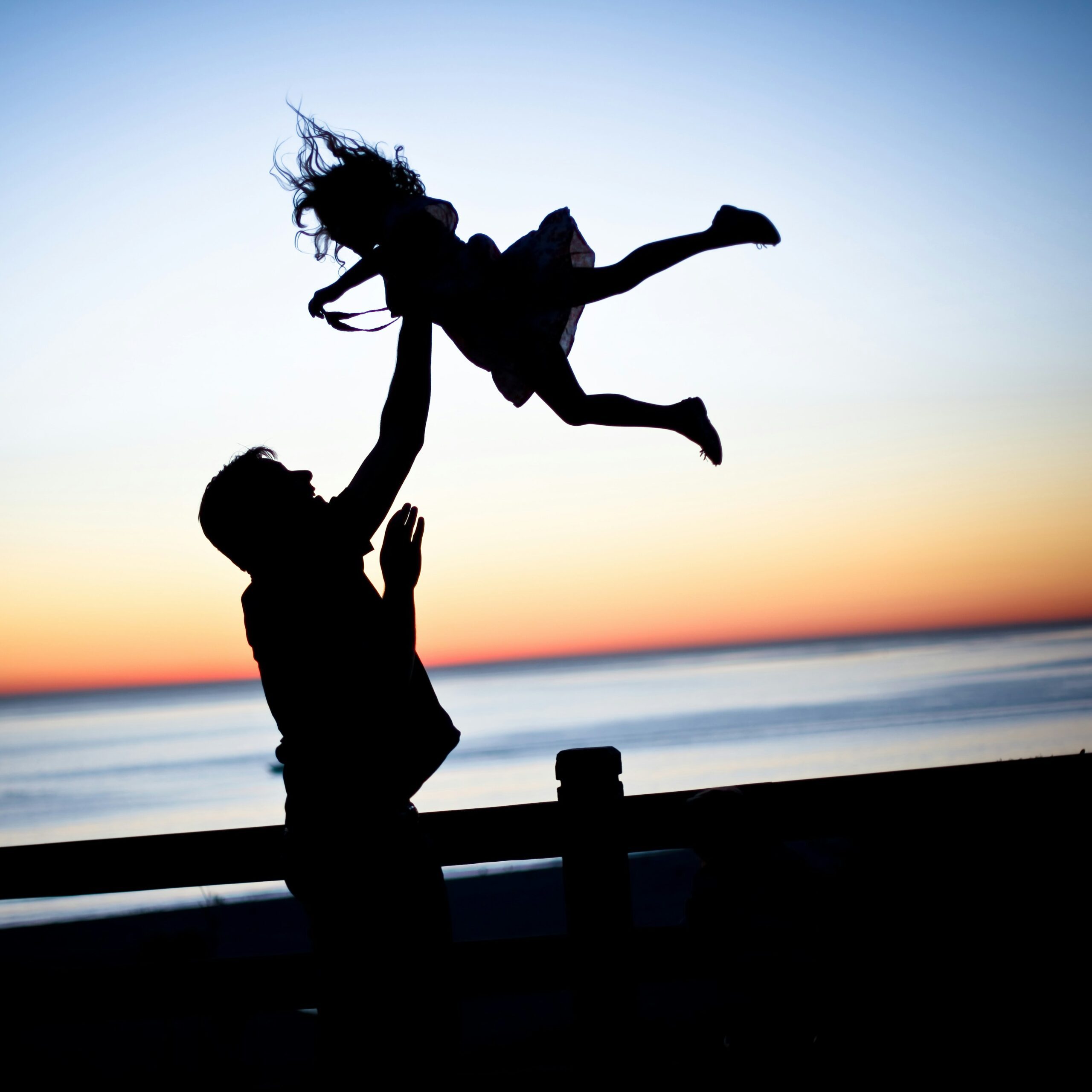 A father tossing his daughter in the air. Learn which types of adoption in New Jersey best fit your family, from domestic and stepparent to international adoption.
