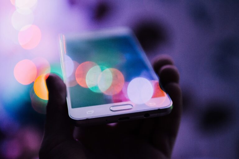 Hand holding on a smartphone where his digital assets are stored. Digital assets and your will.